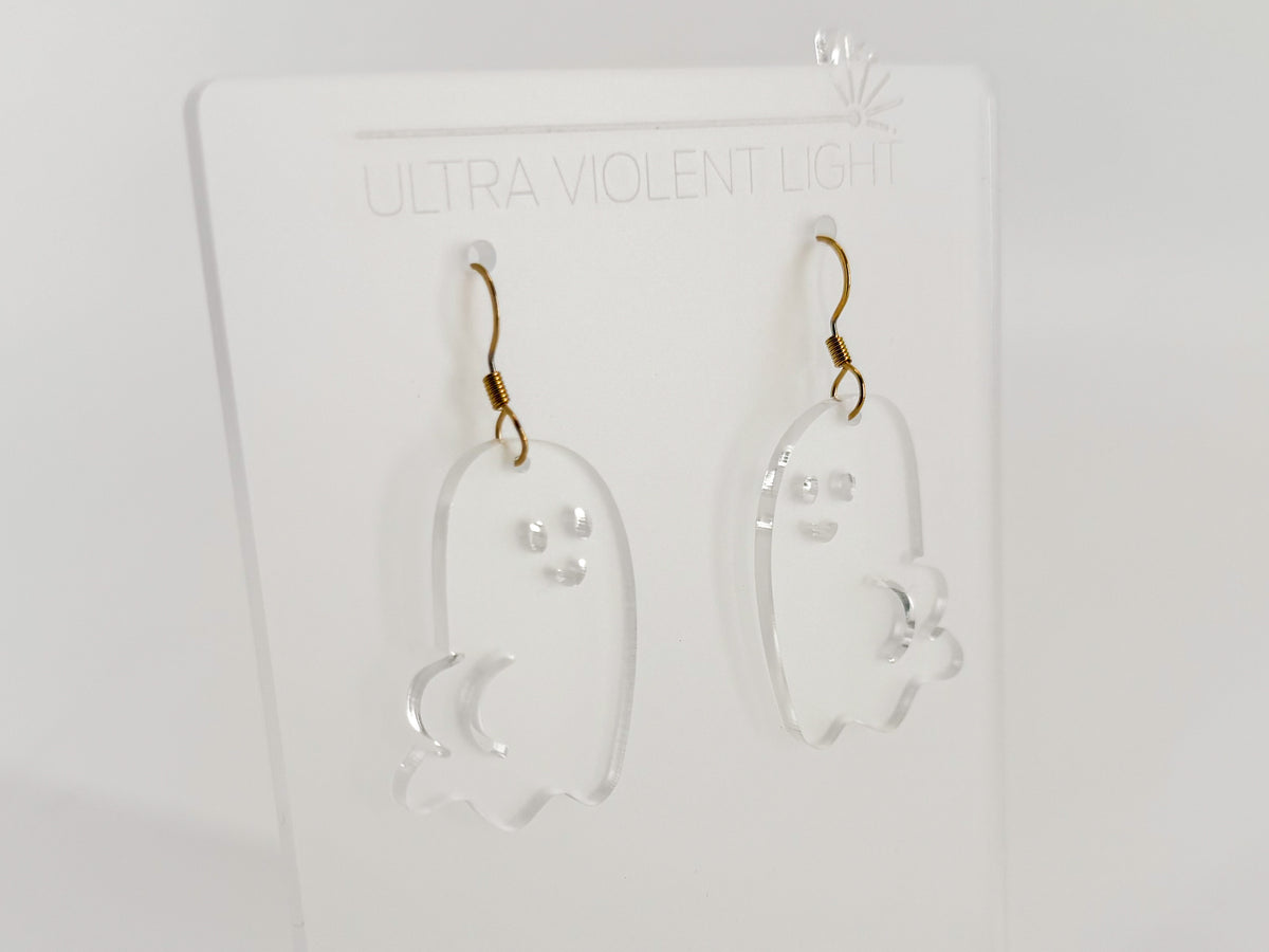 Angled view of frosted clear acrylic Ghost BOOty earrings with smiling faces, booty details, and gold-colored hook findings.
