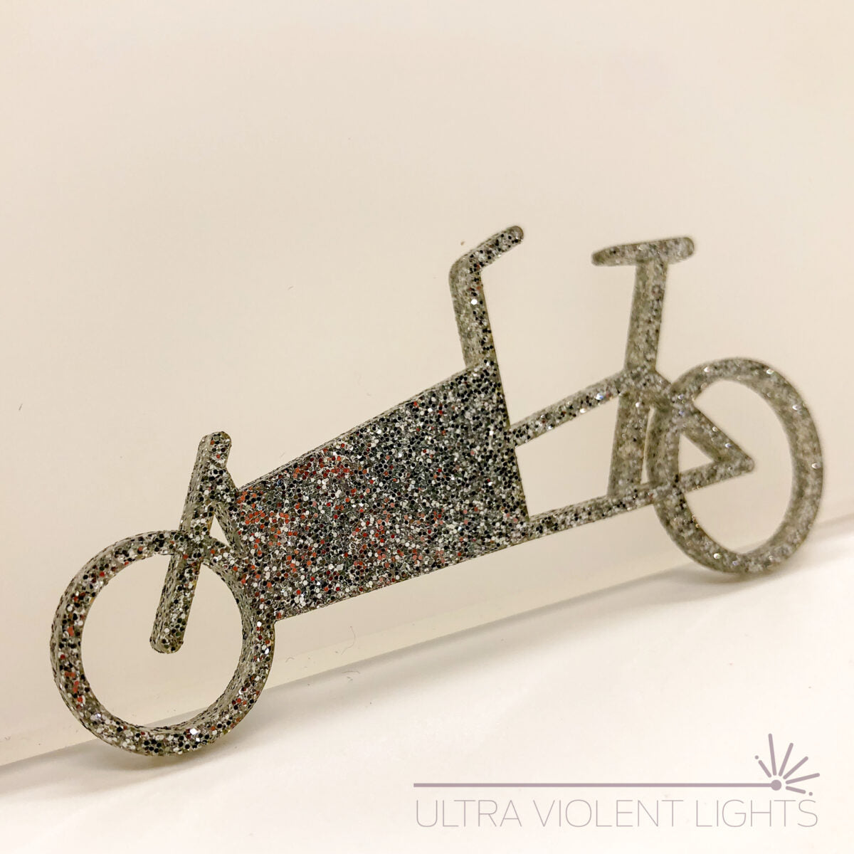 A box bike figure in silver acrylic
