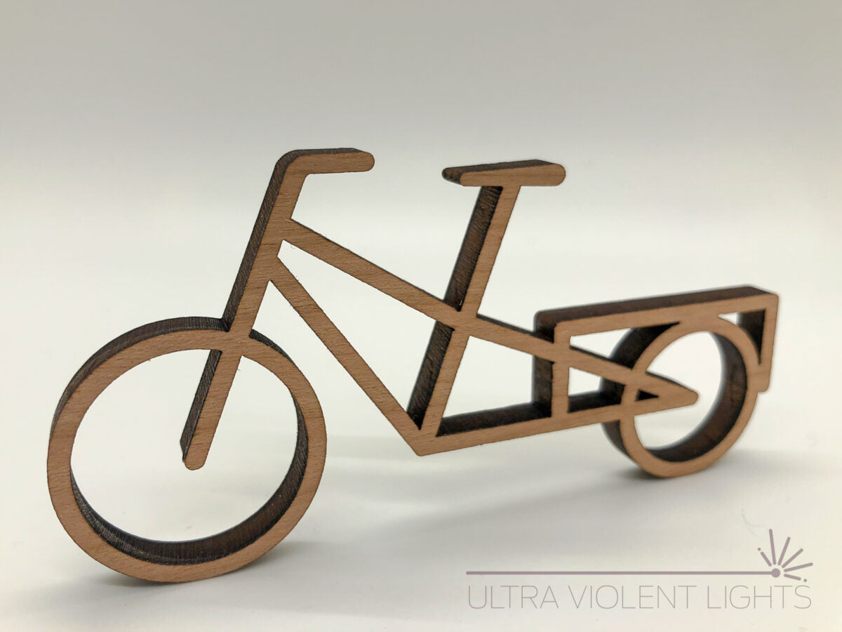 A longtail bike figure in maple