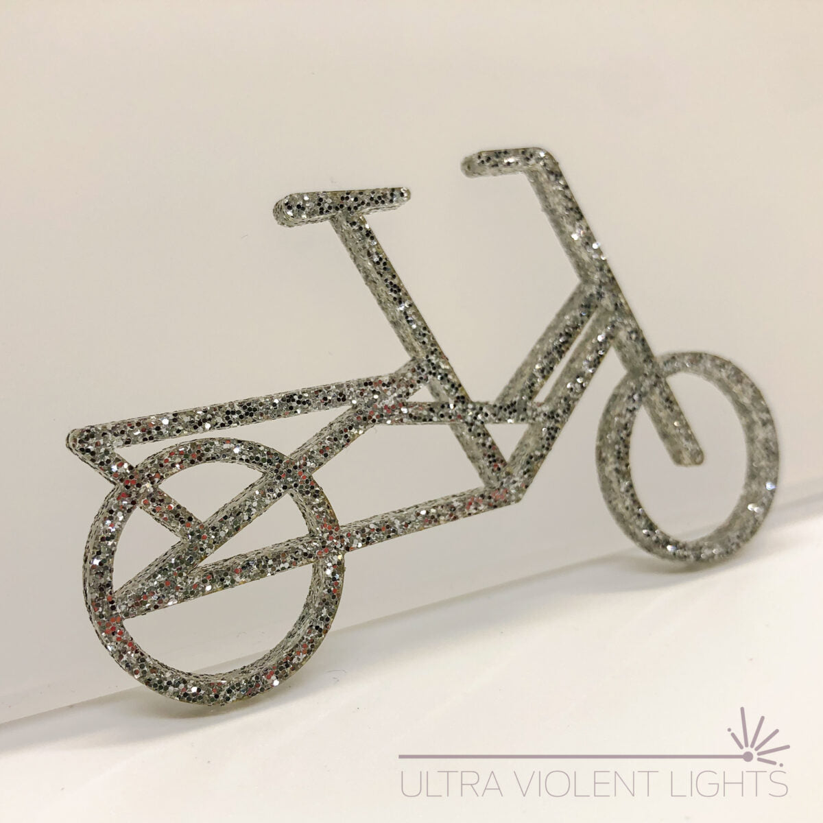 A Midtail bike figure in gold acrylic