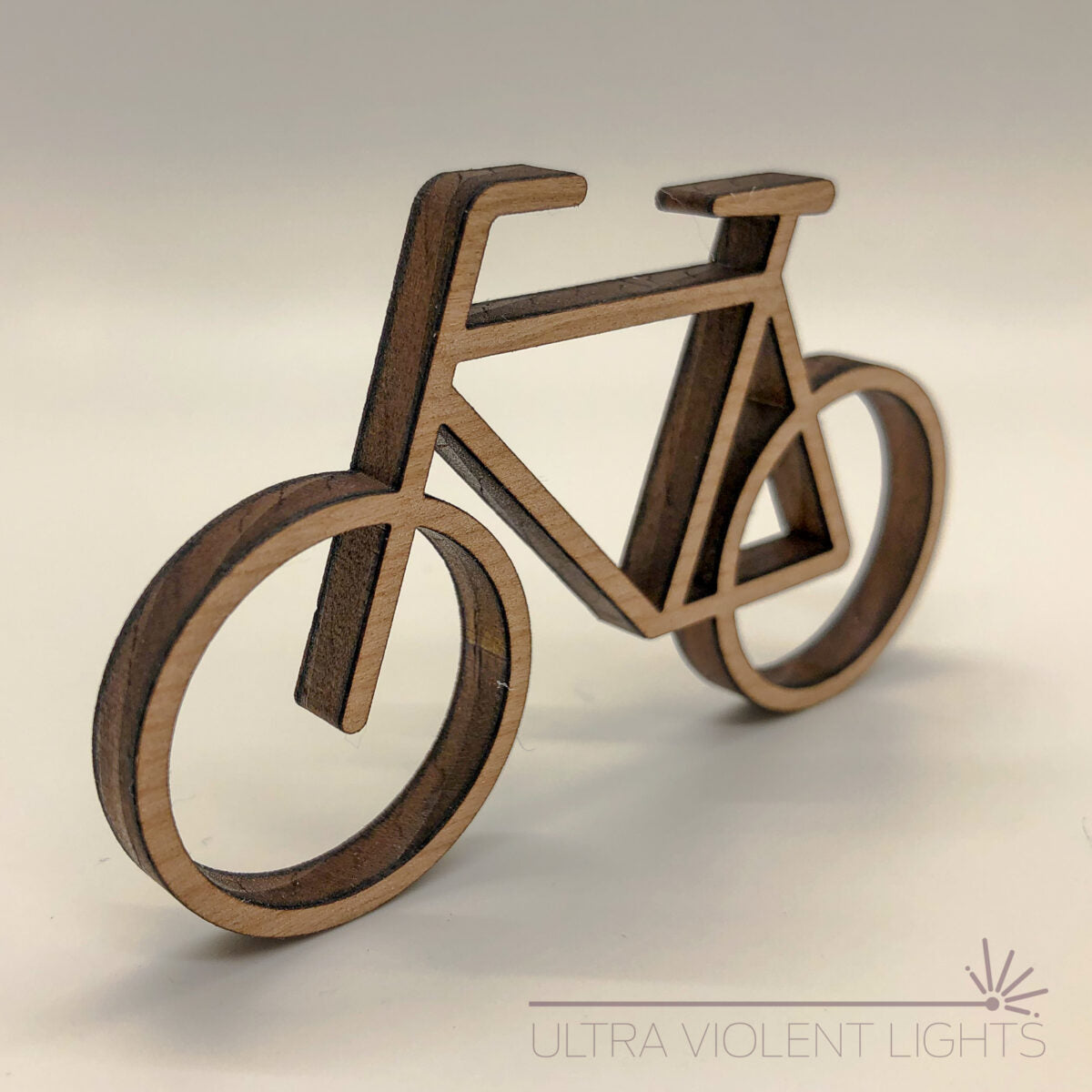 A single bike figure in maple