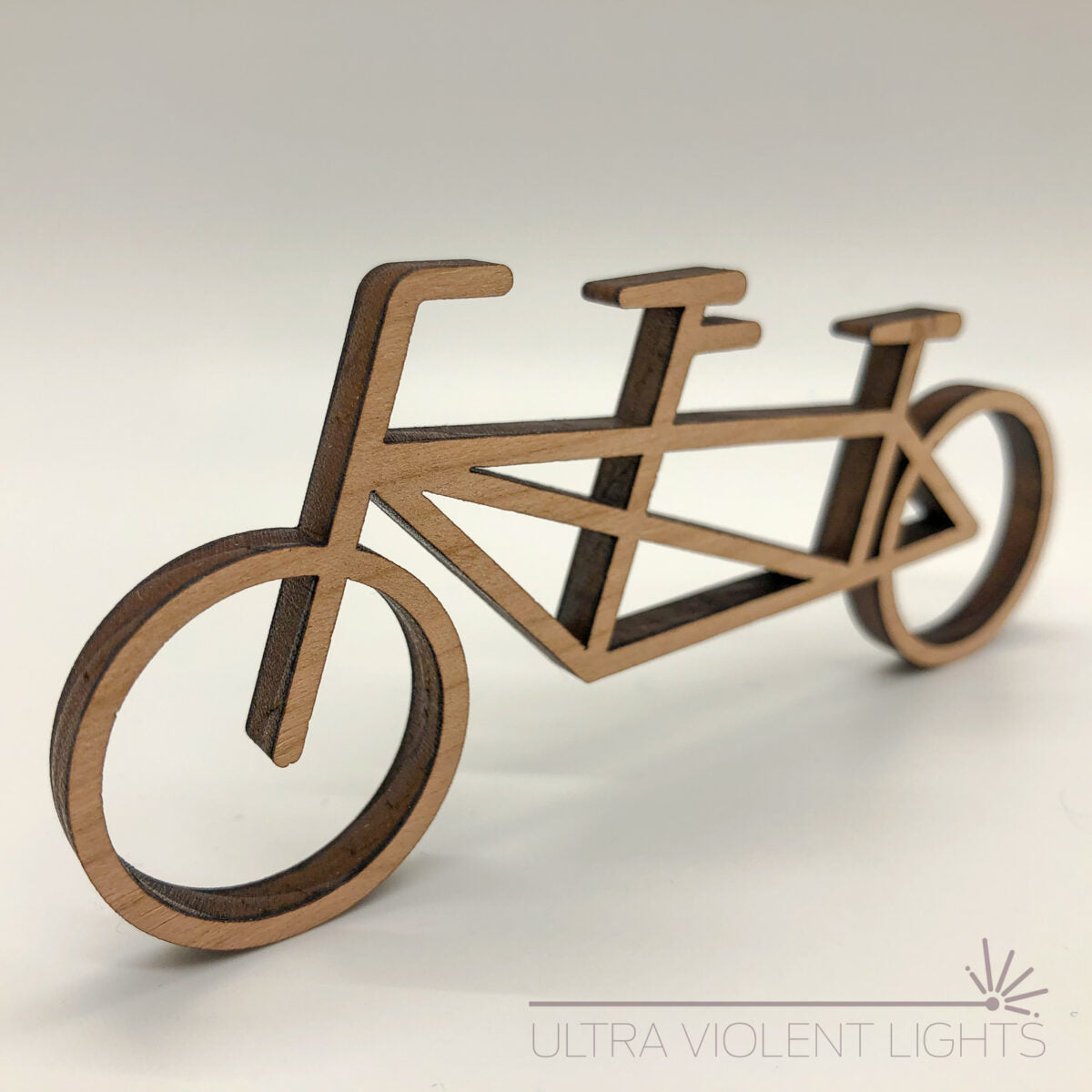 A tandem bike figure in maple