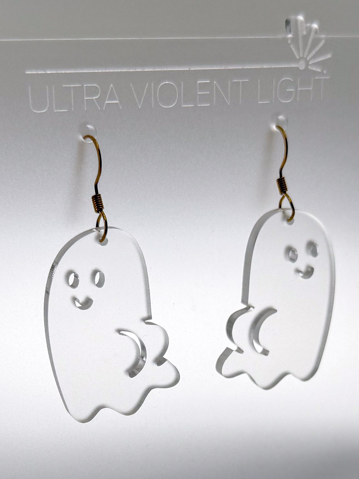 Ghost BOOty earrings in frosted clear acrylic, featuring smiling ghosts with cheeky booty details and gold-colored hook findings