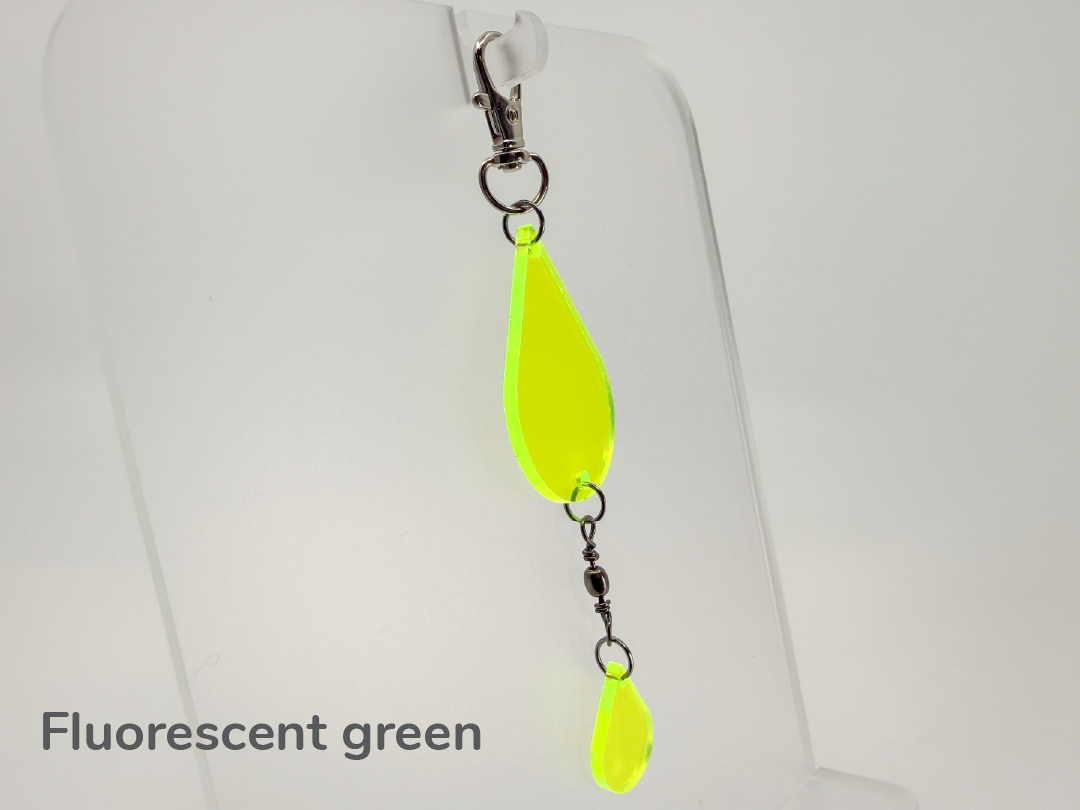 Fluorescent green teardrop-shaped small sun catcher / keychain on a white background