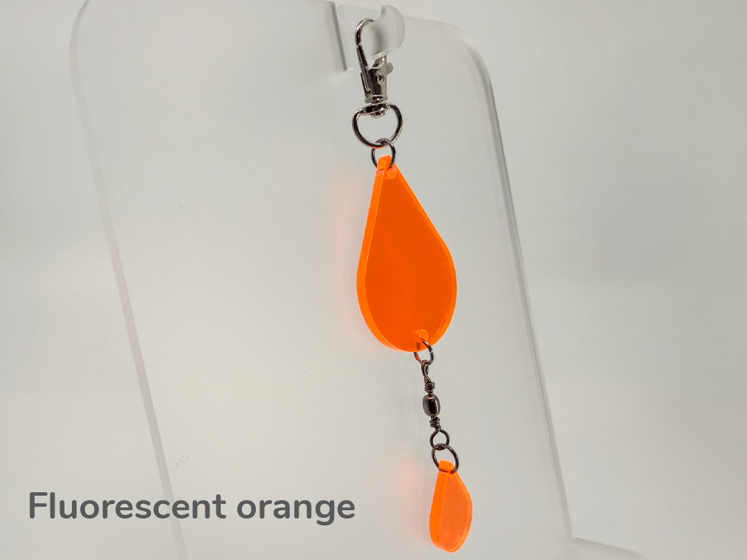 Fluorescent orange teardrop-shaped keychain / sun catcher on a white background