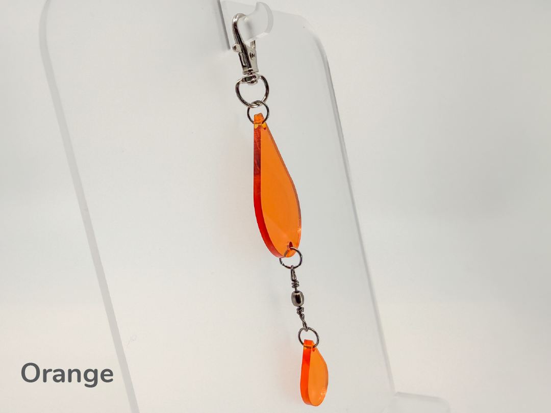 Orange teardrop-shaped small sun catcher / keychain on a white background