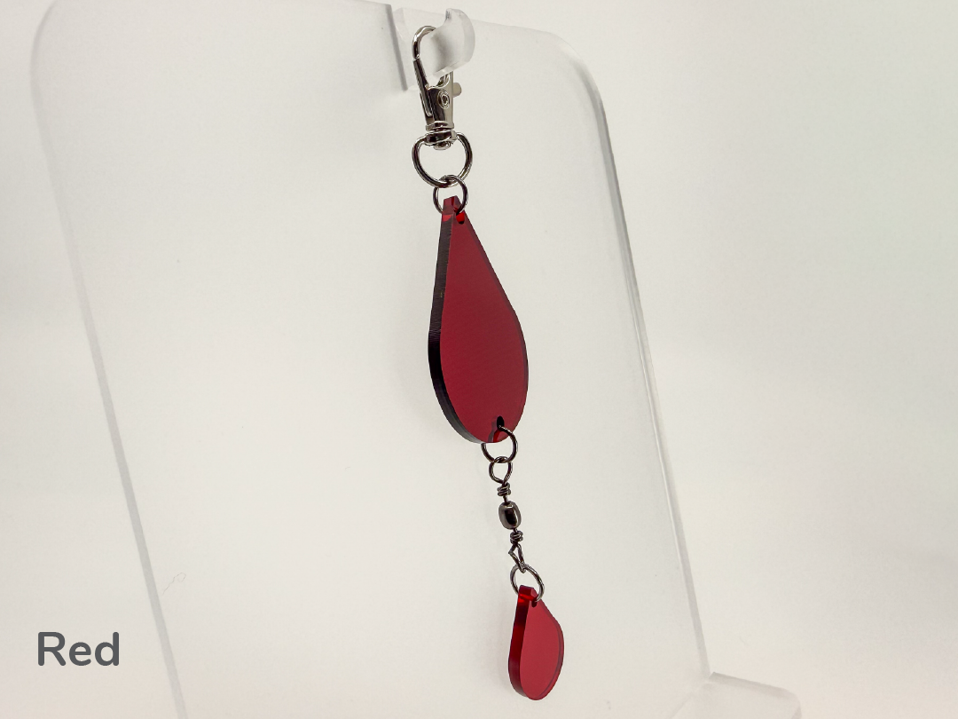 Red teardrop-shaped small sun catcher / keychain on a white background