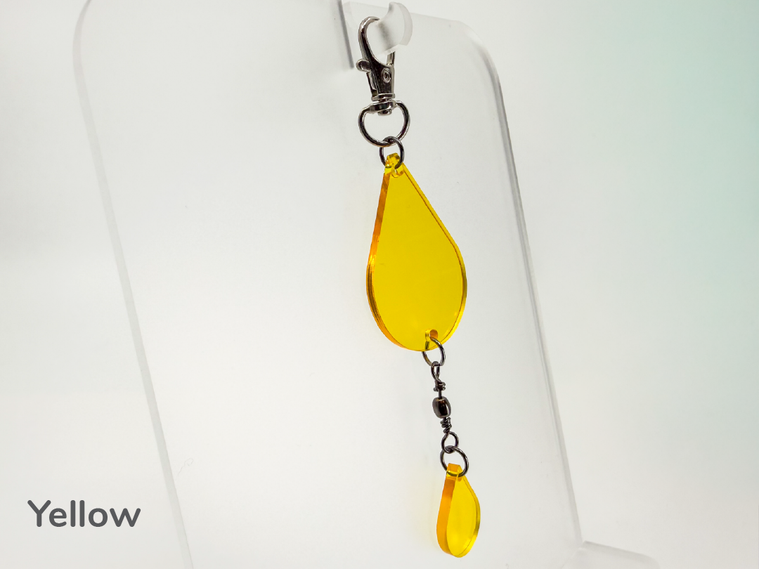 Yellow teardrop-shaped small sun catcher / keychain on a white background