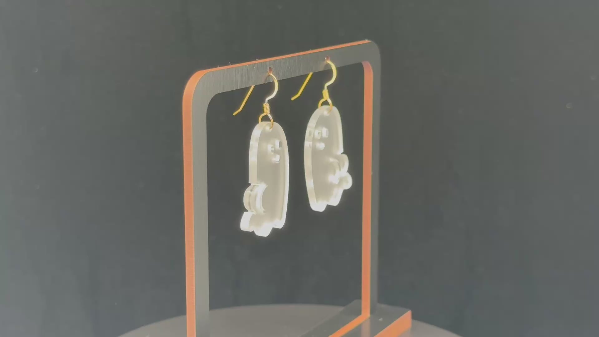 Ghost BOOty earrings with gold-colored hook findings on a wooden display.