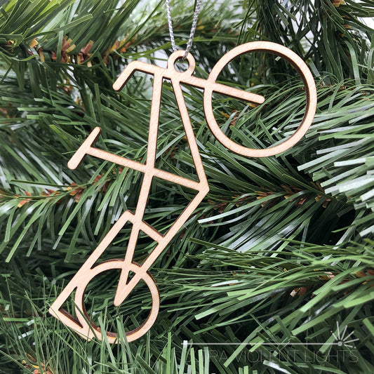 Wooden longtail bicycle ornament on greenery