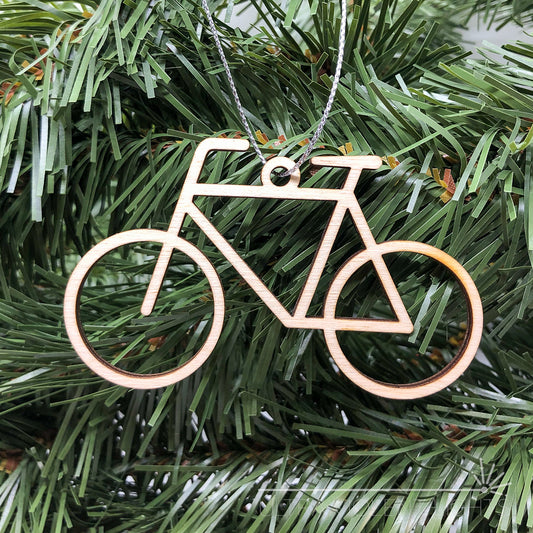 Single wooden bicycle ornament on greenery