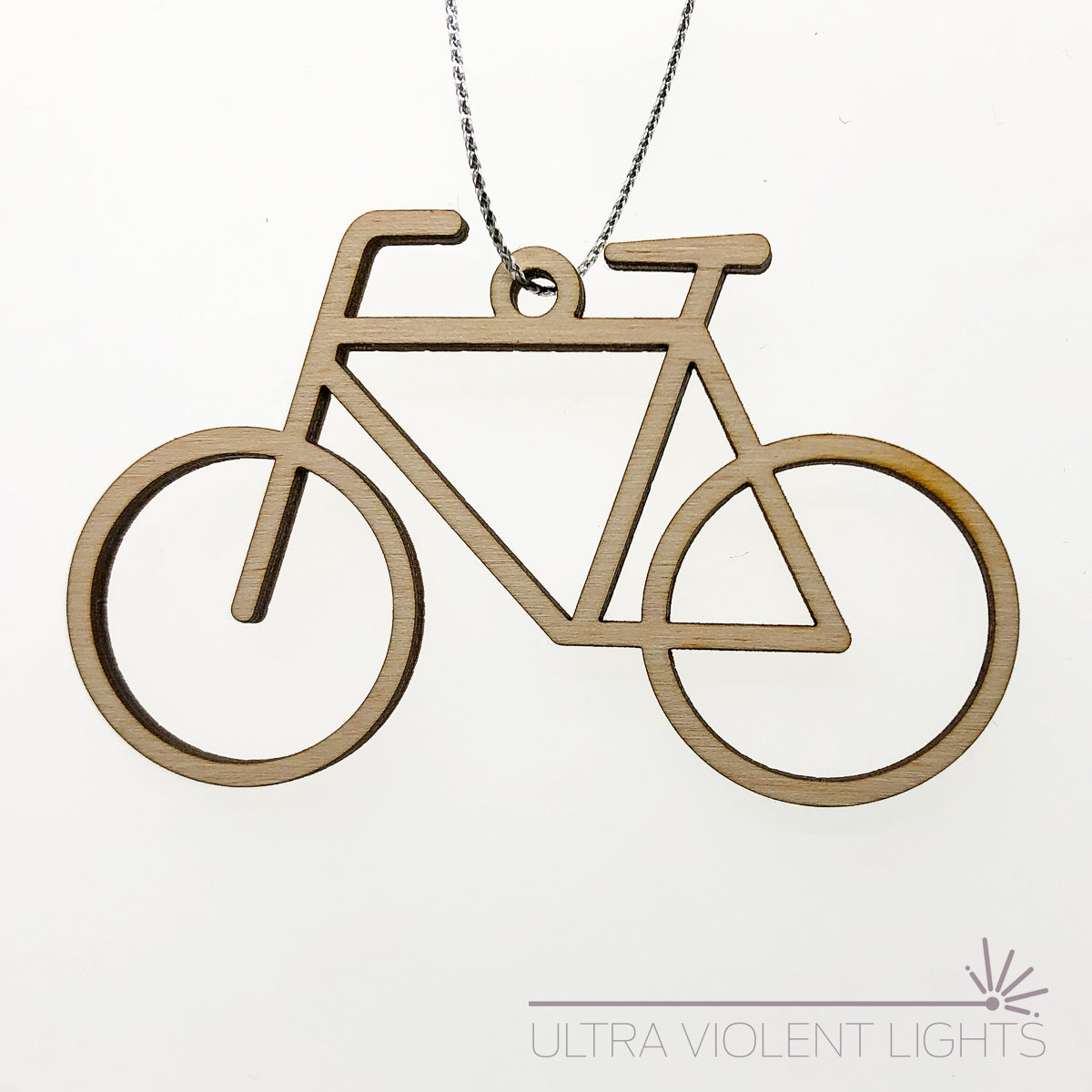 Single wooden bicycle ornament on white