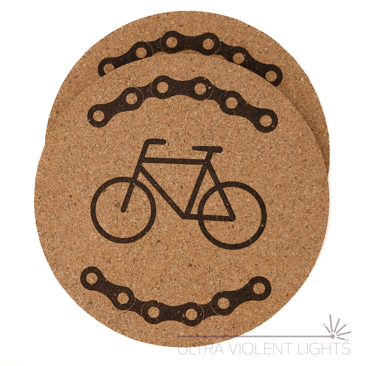 Two cork coasters engraved with bike chains and a bike