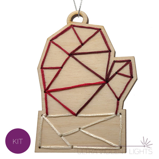 A mitten wooden embroidery kit with variegated red thread as well as ecru.
