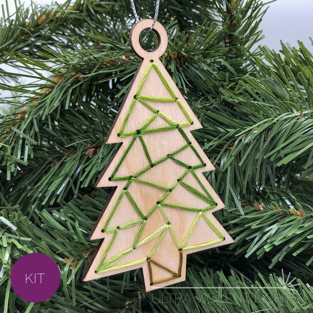 Triangle tree wooden embroidery ornament on greenery