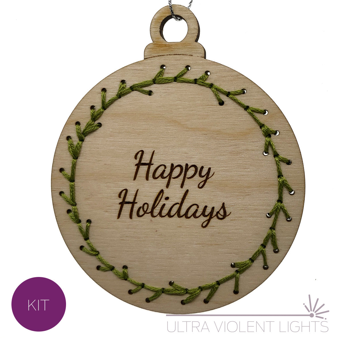 Happy Holidays on a wooden ornament embroidered with green floss